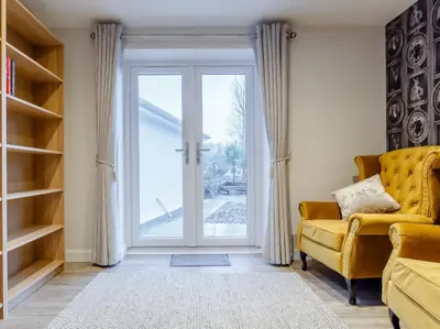 a living room with a sliding glass door at 6 Bed in Penzance oc-77228 in Saint Hilary