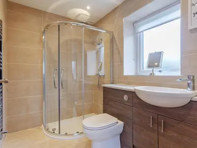 a bathroom with a shower and a toilet and a sink at 6 Bed in Penzance oc-77228 in Saint Hilary