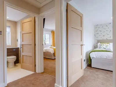 a bathroom with a bedroom with a bed and a toilet at 6 Bed in Penzance oc-77228 in Saint Hilary