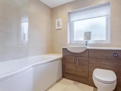 a bathroom with a toilet and a sink and a bath tub at 6 Bed in Penzance oc-77228 in Saint Hilary