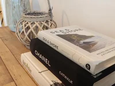 three books stacked on top of each other on a table at 31 Cliff Edge in Newquay