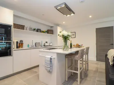 a kitchen with a counter with a vase of flowers on it at 31 Cliff Edge in Newquay