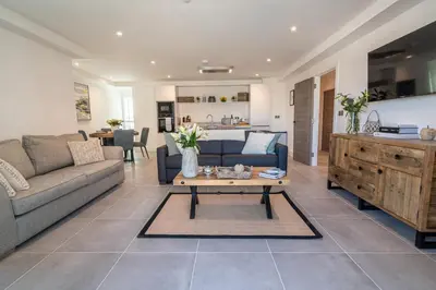 a living room with a couch and a table at 31 Cliff Edge in Newquay