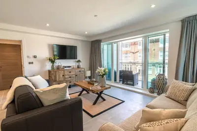 a living room with a couch and a tv at 31 Cliff Edge in Newquay