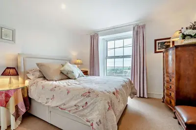 a bedroom with a bed and a window and a dresser at 3 Bed in St. Breward oc-g28144 in Saint Breward