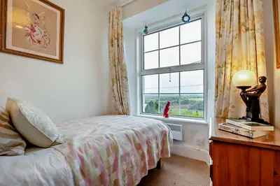 a bedroom with a bed and a window at 3 Bed in St. Breward oc-g28144 in Saint Breward
