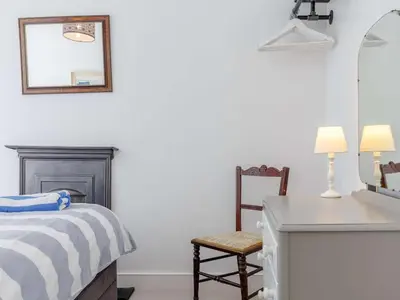 a bedroom with a bed and a desk and a mirror at 2 Bed in Par- oc-81252 in Saint Blazey