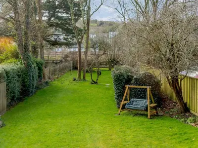 a garden with a sign in the grass at 2 Bed in Par- oc-81252 in Saint Blazey