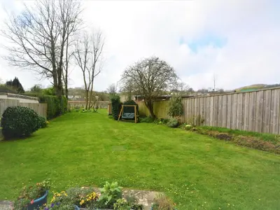 a large yard with a fence and a playground at 2 Bed in Par- oc-81252 in Saint Blazey