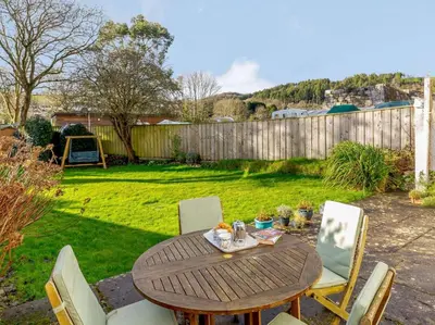 a wooden table and chairs in a yard at 2 Bed in Par- oc-81252 in Saint Blazey