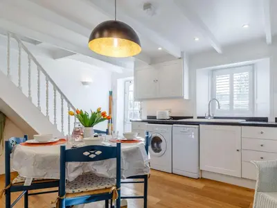 a kitchen with a table and a sink and a dishwasher at 2 Bed in Par- oc-81252 in Saint Blazey