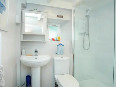a bathroom with a toilet and a sink and a shower at The Lookout in Polruan