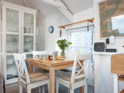 a dining room with a wooden table and chairs at The Lookout in Polruan
