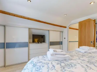 a bedroom with a bed with towels on it at 2 Bed in Holsworthy oc-82455 in Week Saint Mary