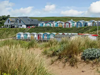 a row of colorful houses on a beach at 2 Bed in Holsworthy oc-82455 in Week Saint Mary