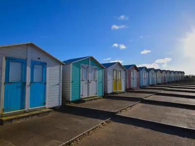 a row of colourful beach huts on the beach at 2 Bed in Holsworthy oc-82455 in Week Saint Mary