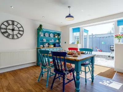 a dining room with a blue table and chairs at 2 Bed in Holsworthy oc-82455 in Week Saint Mary
