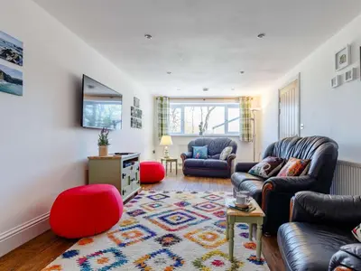 a living room with two couches and a rug at 2 Bed in Holsworthy oc-82455 in Week Saint Mary