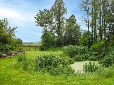 a garden with a pond in the middle of a field at 2 Bed in Launceston oc-85894 in South Petherwin