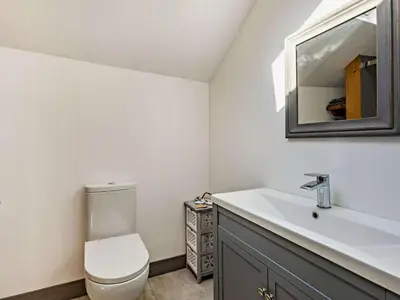 a bathroom with a toilet and a sink and a mirror at 2 Bed in Launceston oc-85894 in South Petherwin
