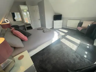 a living room with a bed and a couch at Hengar Manor 4 bed Sleeps 9 in Saint Tudy