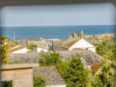 a view of roofs of houses and the ocean at 2 Bed in St. Austell oc-88402 in Mevagissey
