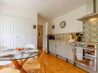 a kitchen with a dining room table and a table and chairs at 2 Bed in St. Austell oc-88402 in Mevagissey