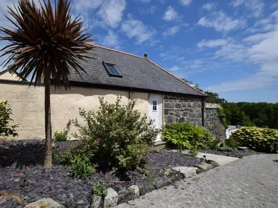 a house with a palm tree in front of it at 1 Bed in Helston oc-41377 in Cury