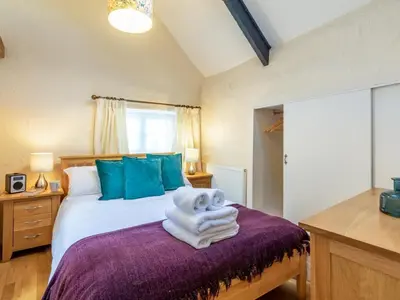 a bedroom with a bed with towels on it at 1 Bed in Helston oc-41377 in Cury