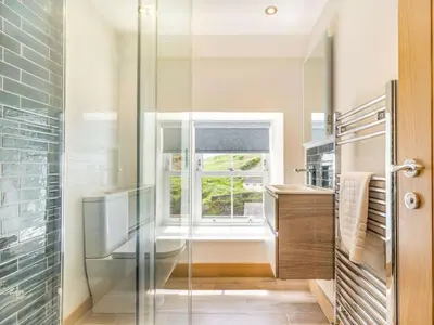 a glass shower in a bathroom with a window at 3 Bed in Truro oc-87260 in Portloe