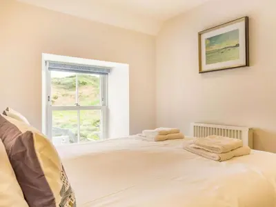 a bedroom with a bed with two towels on it at 3 Bed in Truro oc-87260 in Portloe