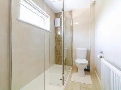 a bathroom with a shower and a toilet at Cres in Tintagel
