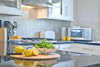 a kitchen with a bowl of lemons on a cutting board at Fistral beachside escape - dramatic ocean views in Crantock