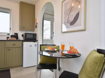 a kitchen with a table with two plates of food on it at 1 Bed in Nr Bude oc-penke in Saint Gennys
