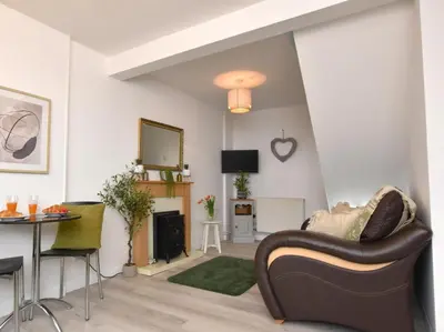 a living room with a couch and a table at 1 Bed in Nr Bude oc-penke in Saint Gennys