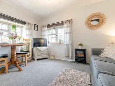 a living room with a couch and a table at 1 Bed in Bude oc-tchawth in Saint Gennys