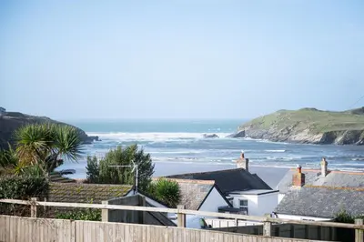 a view of a beach with houses and the ocean at Mermaid Gaze in Porth, Newquay in Newquay