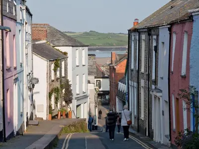 a group of people walking down a street at 2 Bed in Wadebridge oc-82682 in Little Petherick