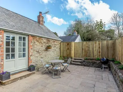 a patio with a table and chairs and a fence at 2 Bed in Wadebridge oc-82682 in Little Petherick