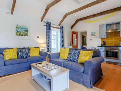 a living room with two blue couches and a table at 2 Bed in Wadebridge oc-82682 in Little Petherick