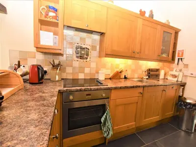 a kitchen with wooden cabinets and a stove top oven at 2 Bed in Launceston oc-congs in North Hill