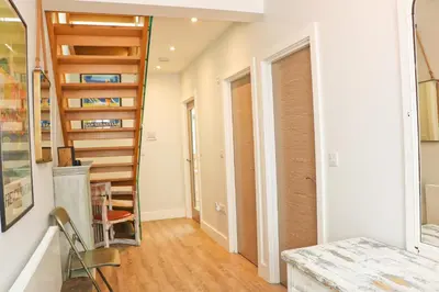 a hallway with a spiral staircase in a house at Stylish townhouse in Padstow in Padstow