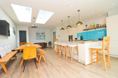 a kitchen and dining room with a table and chairs at Stylish townhouse in Padstow in Padstow