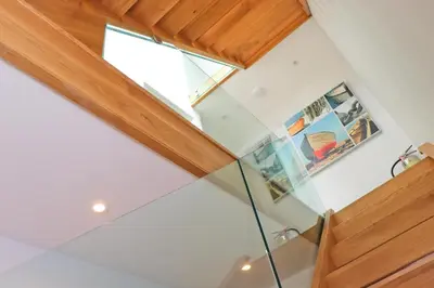 an attic conversion of a house with a glass ceiling at Stylish townhouse in Padstow in Padstow