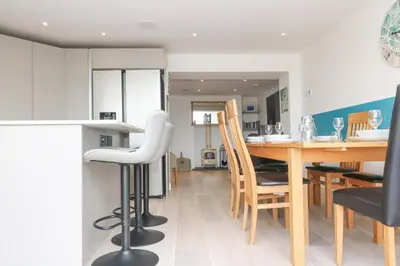 a kitchen and dining room with a table and chairs at Sailors in Falmouth
