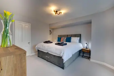 a bedroom with a bed and a vase of flowers at 3 Bed in Fowey oc-p00803 in Fowey