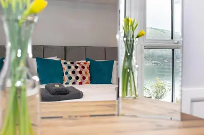 a living room with a couch and a table with vases at 3 Bed in Fowey oc-p00803 in Fowey
