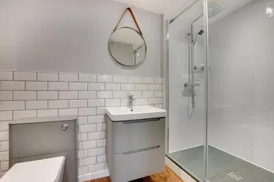 a white bathroom with a sink and a mirror at 3 Bed in Fowey oc-p00803 in Fowey