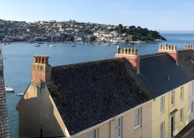 an aerial view of a building and a body of water at La Folie, Fowey in Fowey