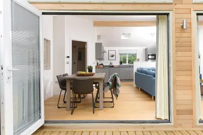 a kitchen and living room with a table and chairs at 5 Southern Place in Liskeard